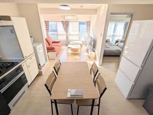 a dining room with a table and chairs in a room at Chateau Sunrise in Tokyo