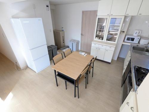 a kitchen with a table and chairs in a room at Chateau Sunrise in Tokyo