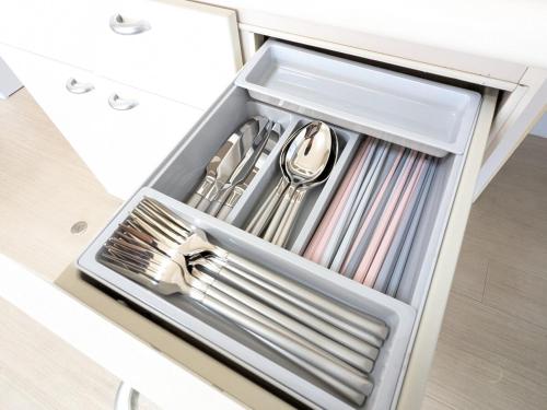 a drawer filled with utensils in a white kitchen at Chateau Sunrise in Tokyo