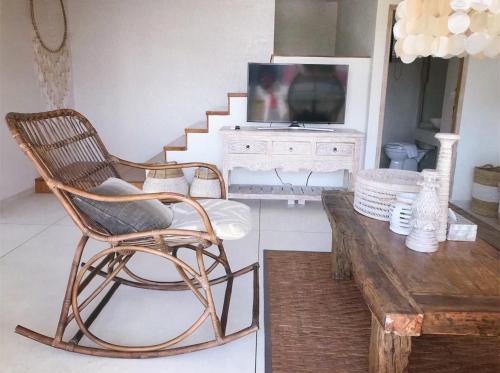 a living room with a rocking chair and a television at Villa S in Hua Hin