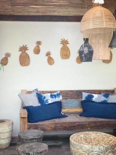 a room with a wooden bench with blue pillows at Villa S in Hua Hin