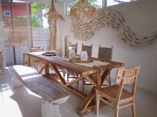 a wooden table and chairs in a room at Villa S in Hua Hin
