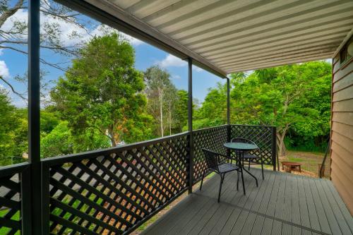a screened in porch with a table and chair on it at The Archer Retreat in Villeneuve