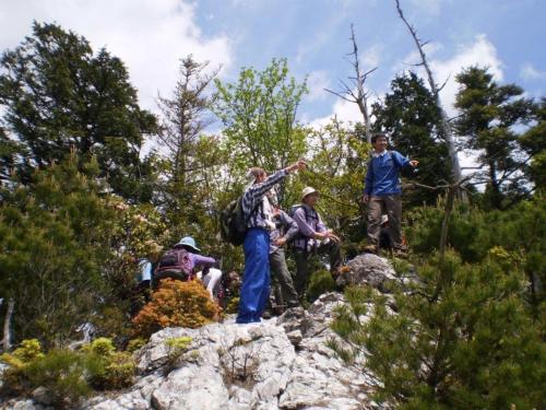a group of people standing on rocks on a trail at 奥伊勢フォレストピア in Ema