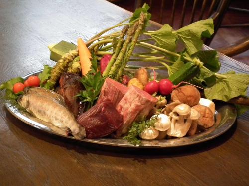 a plate of food with vegetables on a table at 奥伊勢フォレストピア in Ema