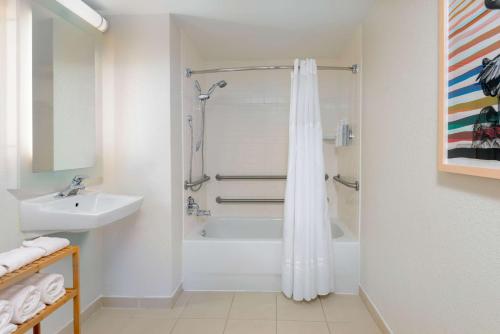 a bathroom with a shower and a sink at Homewood Suites by Hilton Bonita Springs, FL in Bonita Springs
