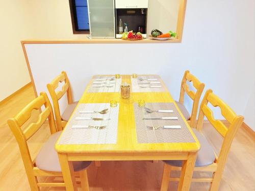 a wooden table with four chairs and a table at 西戸崎6丁目13番3号 in Fukuoka