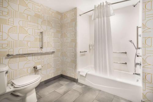 a bathroom with a toilet and a tub and a shower at Home2 Suites By Hilton Reynoldsburg Columbus East in Columbus
