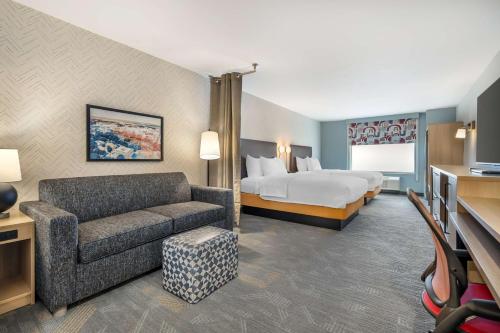 a hotel room with a bed and a couch at Home2 Suites By Hilton Reynoldsburg Columbus East in Columbus