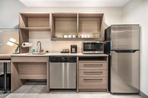 a kitchen with a stainless steel refrigerator and a sink at Home2 Suites By Hilton Reynoldsburg Columbus East in Columbus