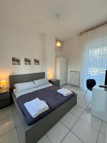 a bedroom with a large bed with two towels on it at Villa Gennari vista mare in Gradara