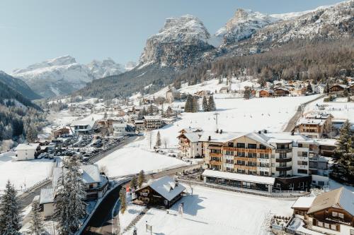 a town covered in snow with mountains in the background at Hotel Antines in La Villa