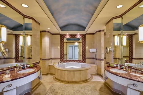 a large bathroom with two sinks and a tub at Hilton Cairo Grand Nile in Cairo
