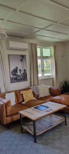 a living room with a couch and a coffee table at Yellow Pot House in Havelock North