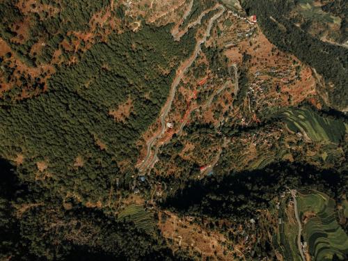 an aerial view of a river in a forest at ila comfort in Bāglung