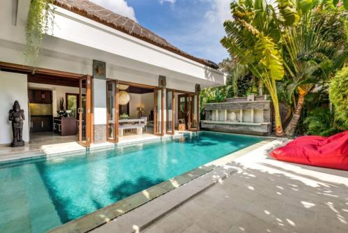 a pool in the backyard of a villa at The Residence Seminyak in Seminyak