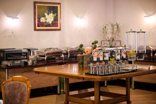 a table with a bunch of bottles and glasses on it at Хотел "Скалите", Skalite Hotel in Belogradchik