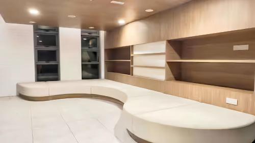 a living room with a bench and shelves at The Robertson Bukit Bintang in Kuala Lumpur