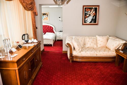 a living room with a couch and a red carpet at Хотел "Скалите", Skalite Hotel in Belogradchik