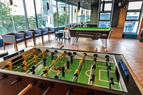 a billiards table in a room with a pool at The Robertson Bukit Bintang in Kuala Lumpur