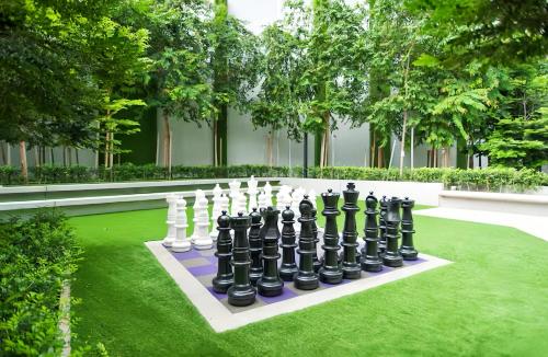 a chess board on a lawn in a garden at The Robertson Bukit Bintang in Kuala Lumpur