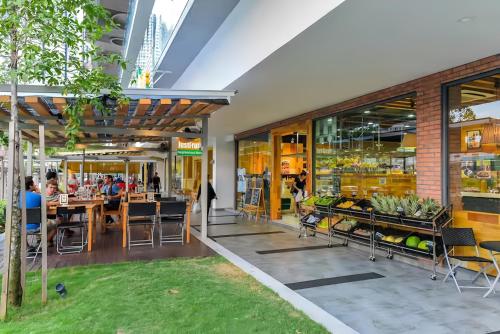 a restaurant with tables and chairs in a building at The Robertson Bukit Bintang in Kuala Lumpur