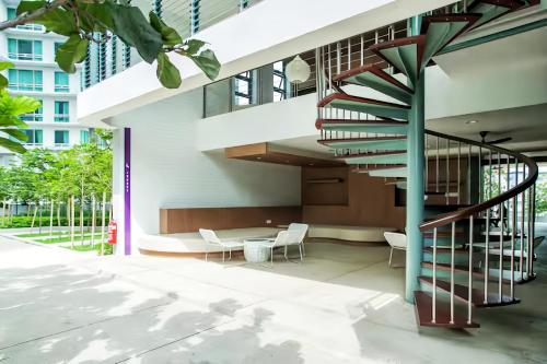 a staircase in a building with chairs and a table at The Robertson Bukit Bintang in Kuala Lumpur