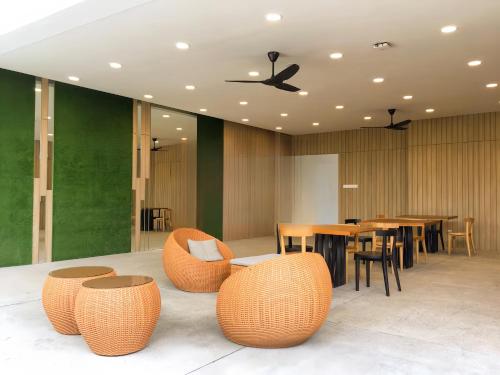 a restaurant with chairs and tables and a ceiling fan at The Robertson Bukit Bintang in Kuala Lumpur