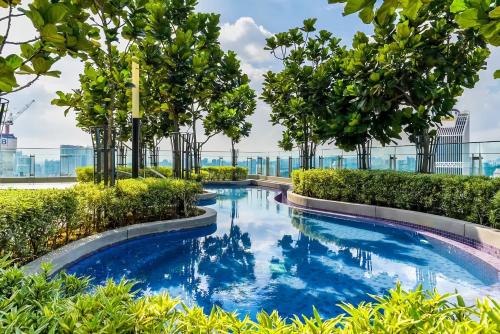 a swimming pool with trees and blue water at The Robertson Bukit Bintang in Kuala Lumpur