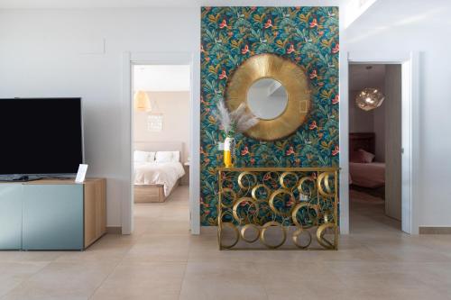 a living room with a mirror on a wall at Begoña Sea View in Fuengirola