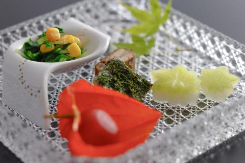 a plate of food with vegetables on a table at Kasyouen Bettei Fuka - Adult Only in Kyotango