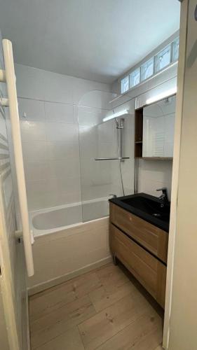 une salle de bain avec une baignoire et un lavabo dans l'établissement Résidence Roche Mantel - APPARTEMENT ALPE D'HUEZ 25m2 ECLOSE EST MAE-0551, à Huez