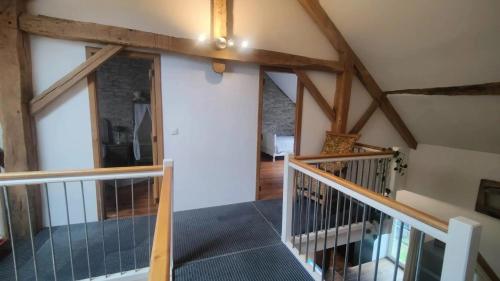a view of a staircase in a house at House with jacuzzi in Menufontaine, 180 m² for 8 people. in Menufontaine