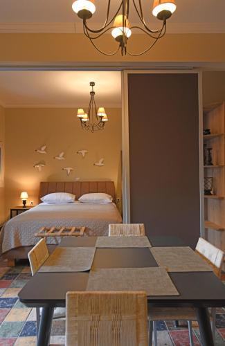 a bedroom with a bed with birds on the wall at Seagulls' House in Evdilos