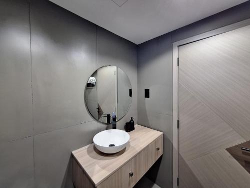 a bathroom with a sink and a mirror at Modern Renovated Studio Building 197 - 5 Min Walking from Metro and Pavilions in Dubai