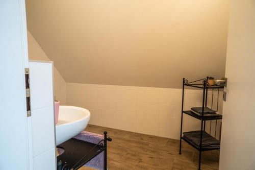 a bathroom with a white tub and a sink at Varalja Apartments in Plavecké Podhradie