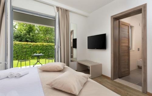 a bedroom with a bed and a large window at Family villa Filton with wellness in Vizinada in Vranje Selo