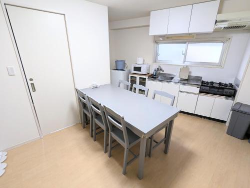 a kitchen with a table and chairs in a room at Chateau Sunrise in Tokyo