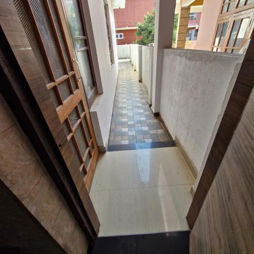 an empty hallway of a building with a stairway at Saatvik Homestay in Katra