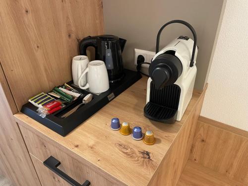 a coffee maker sitting on a shelf in a room at MEIN MOTEL - Self Check-in in Oberndorf am Neckar