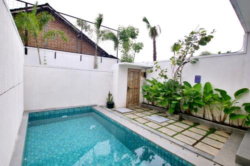 a swimming pool in the backyard of a house at Gauri Vasanta Villa with Private Pool Yogyakarta in Yogyakarta