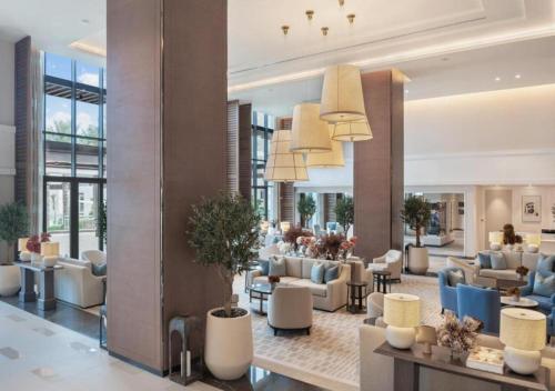 a lobby of a hotel with couches and chairs at Bespoke Holiday Homes - Seaside Luxury 2BR in Address Residence, Fujairah in Fujairah