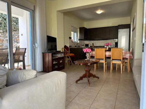 a living room with a couch and a table at Breathtaking sea and Mountain views with Private pool, Peace full relaxing Villa with WiFi near Shops and Restaurants in Epáno Kefalás