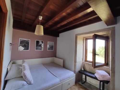 a bedroom with a bed and a window at A Vixía do Roncudo in Corme-Puerto
