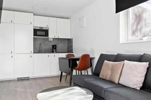 a living room with a couch and a table at First Camp Mölle-Höganäs in Mölle