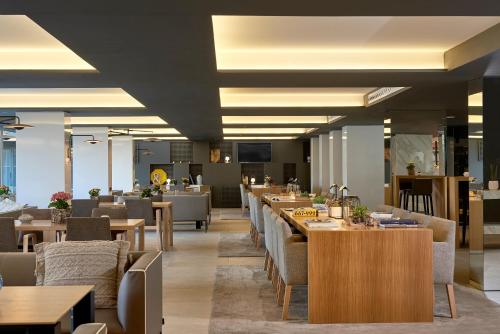 a restaurant with tables and chairs and a cafeteria at INNSiDE by Meliá Palma Bosque in Palma de Mallorca