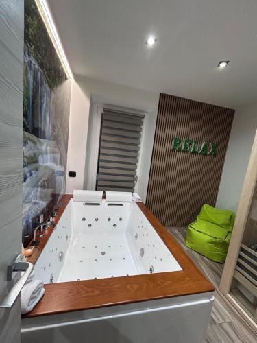 a bathroom with a large tub in a room at Lakes and Mountains Magic Holiday House in Omegna