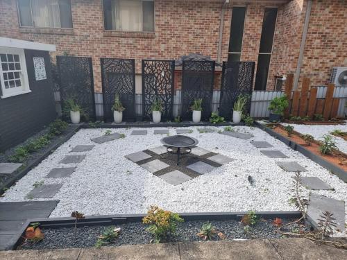 a patio with a table in front of a building at Cozy Heritage Home 10mins walk to Wollongong Hospital with Free Parking and Fast Internet in Wollongong