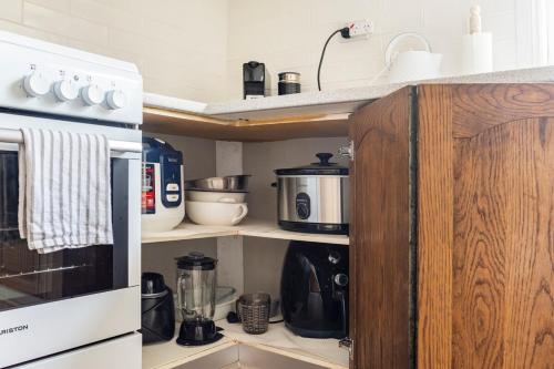 a kitchen with a coffee maker and a microwave at Cozy Heritage Home 10mins walk to Wollongong Hospital with Free Parking and Fast Internet in Wollongong