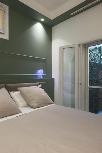a bedroom with a large white bed and a window at Reggio Charme in Reggio Calabria